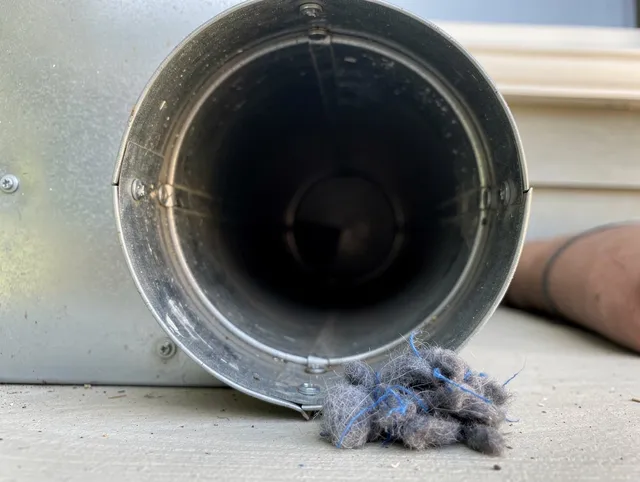 Colorado Springs Dryer Vent Cleaning technician using specialized equipment to clear severe dryer vent blockage in Colorado Springs